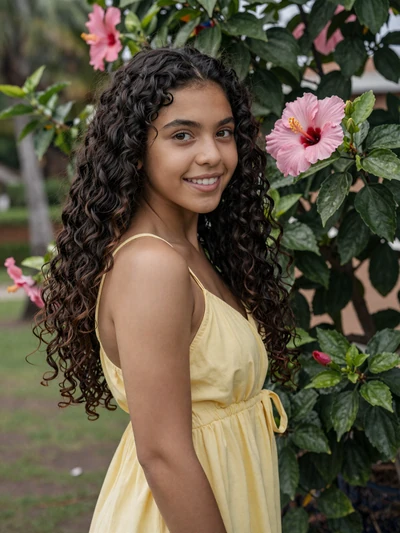 Isabella, 24-year-old petite Puerto Rican woman with tan skin and curly dark hair in yellow dress surrounded by tropical flowers